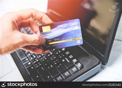 credit card and using laptop easy payment online shopping concept / electronic card in hand for pay online