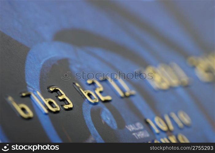 Credit card closeup. Selective focus on gold numbers
