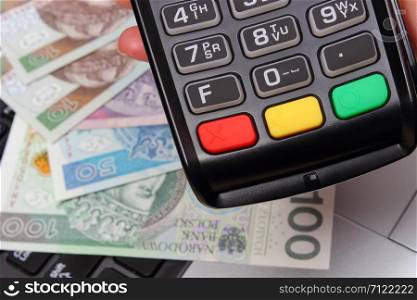 Credit card reader with polish currency money, paying using credit card or cash concept. Credit card reader with polish currency money, finance concept