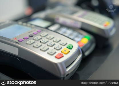 Credit card swipe machine And a young woman holding a credit card to pay for purchases using money from the card. Or installment payments