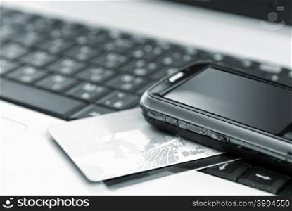 Credit cards and mobile phone on the notebook