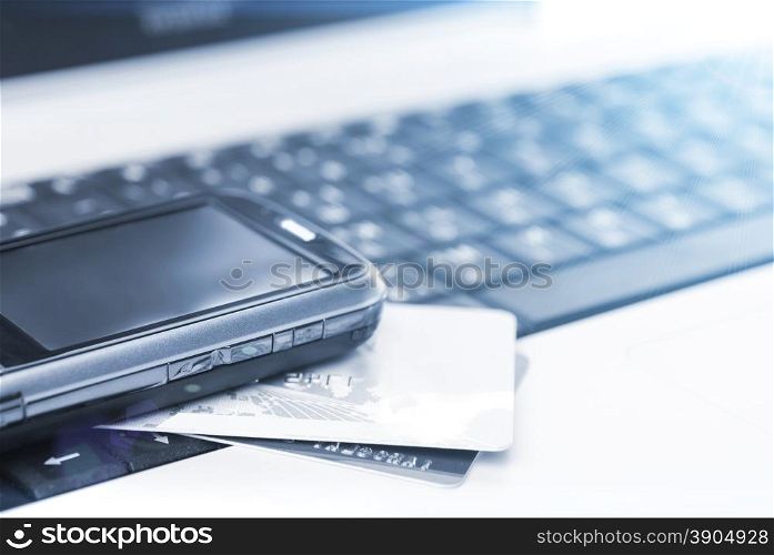 Credit cards and mobile phone on the notebook