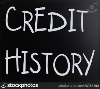 ""Credit history" handwritten with white chalk on a blackboard"