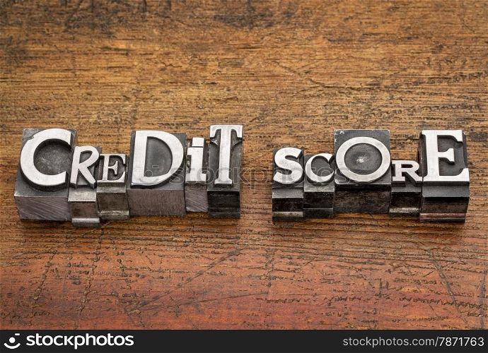 credit score text in mixed vintage metal type printing blocks over grunge wood