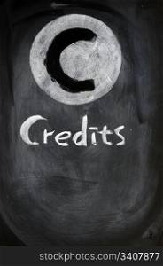 Credits sign written with chalk on a blackboard