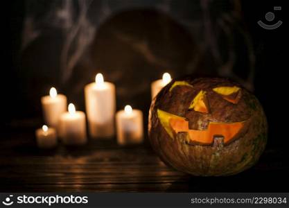 creepy carved pumpkin white candles