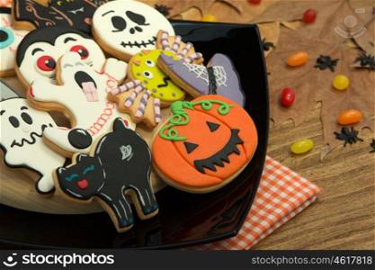 Creepy Halloween cookies and candies on a wooden table