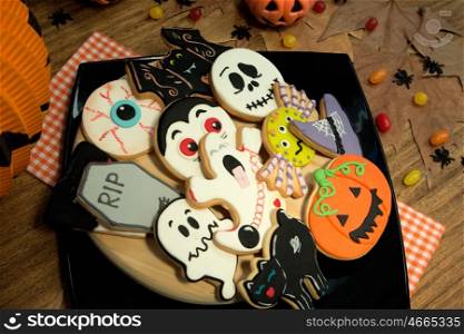Creepy Halloween cookies and candies on a wooden table