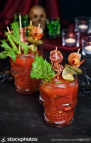 Creepy Halloween party - Caesar or Bloody Mary cocktail containing vodka, some tomato juice, different spices and flavorings, such as Worcestershire sauce, celery. Served with ice in a beer glass