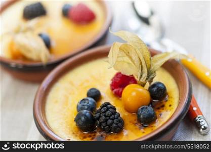 Creme brulee dessert. Sweet creme brulee desserts topped with fresh berries