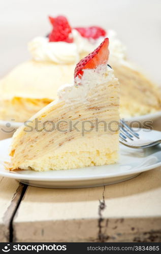 crepe pancake cake with whipped cream and strawberry on top