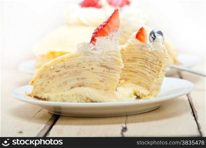 crepe pancake cake with whipped cream and strawberry on top