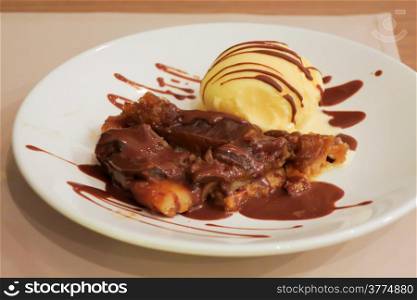 crepe suzette served with vanila ice cream and chocolate sauce