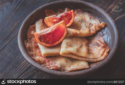 Crepes Suzette with slices of blood orange on the plate