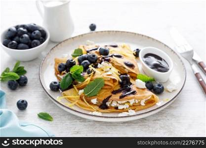 Crepes. Thin pancakes stuffed with cottage cheese and fresh blueberries