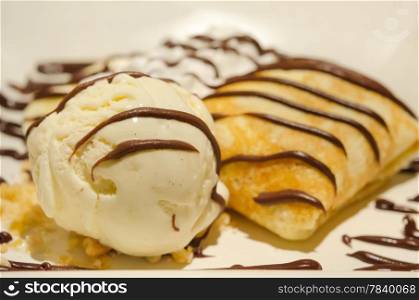 Crepes with banana , chocolate sauce served with whipping cream and vanilla ice cream