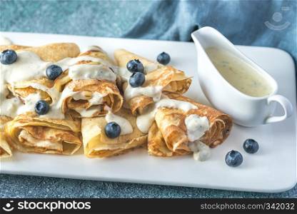 Crepes with blue cheese sauce decorated with fresh blueberries