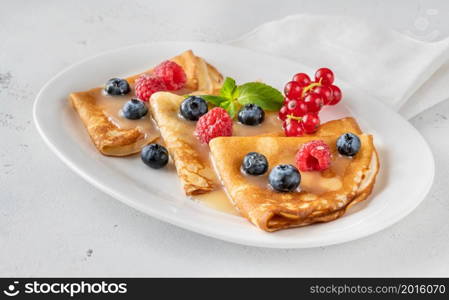 Crepes with fresh raspberries, blueberries and red currant
