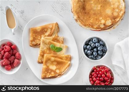 Crepes with fresh raspberries, blueberries and red currant