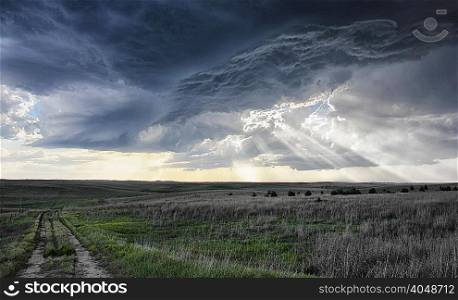 Crepuscular rays forming under shelf cloud, rotating mesocyclone in background, Sidney, Nebraska, USA