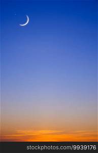 Crescent moon and star on twilight sky vertical background in early morning before sunrise with copy space for editing arabic text, Ramadan kareem, Eid al Adha, Eid al fitr, Mubarak, Islamic New Year