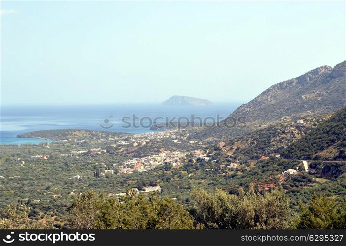 Cretan landscape of a valley with an island and a sea.