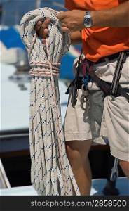 Crew Member Holding Rope During Sailing Race