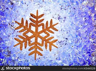 Crhistmas snowflake golden star symbol over blue ice background