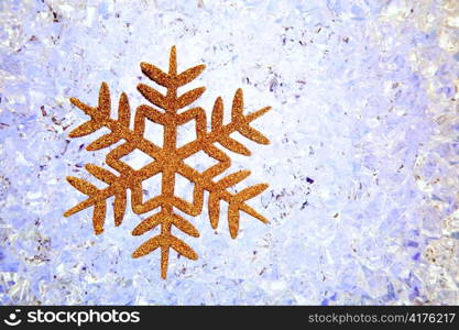 Crhistmas snowflake golden star symbol over ice background