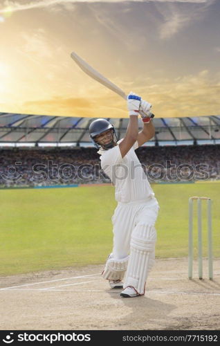 Cricketer batsman hitting a shot