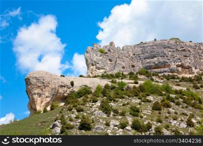 Crimea (Ukraine) mountain landscape . In stony mountain vertical slope - ancient cave settlement (Chufut Kale, Crimea, Ukraine).