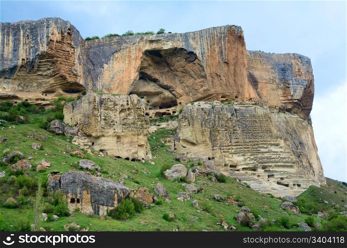 Crimea (Ukraine) mountain landscape. In stony mountain vertical slope - ancient cave settlement Eski-Kermen.