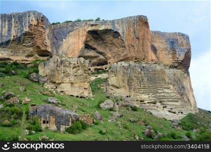 Crimea (Ukraine) mountain landscape. In stony mountain vertical slope - ancient cave settlement Eski-Kermen.