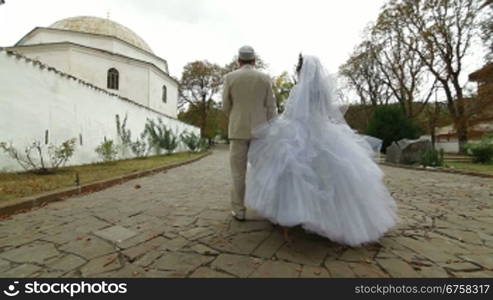 Crimean Tatar newlyweds walking through the park Bakhchisarai Palace (Hansaray, Khan&acute;s Palace) Bakhchisaray, Crimea, Ukraine. lockdown, Wide Shot, Canon 5D Mark II