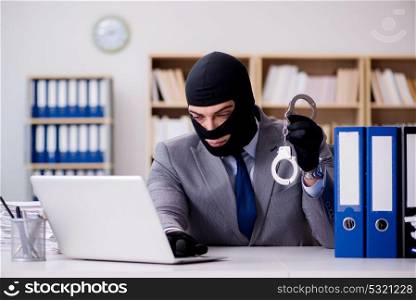 Criminal businessman with balaclava in office