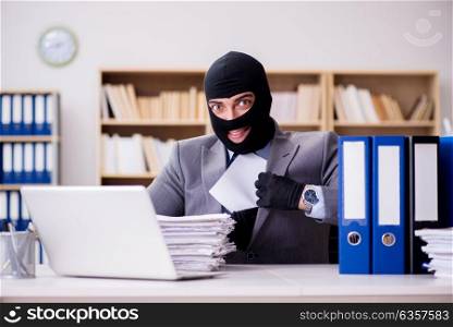 Criminal businessman with balaclava in office