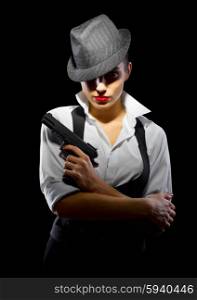 Criminal girl with gun isolated on black background