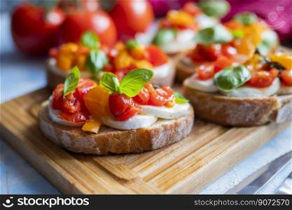 crispy bruschetta bread with mozzarella cheese with tomatoes and basil