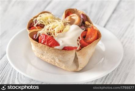 Crispy burrito basket with roasted vegetables and cheese