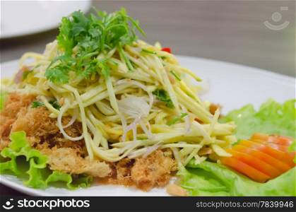 Crispy catfish salad with green mango and vegetable , served with tomato and lettuce