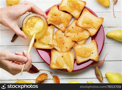 Crispy croutons or tea toast with pear jam.. Pear jam on the bread