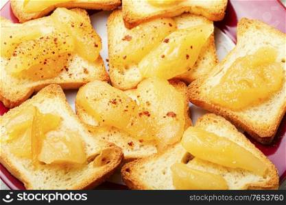 Crispy croutons or tea toast with pear jam.. Toast with pear jam.