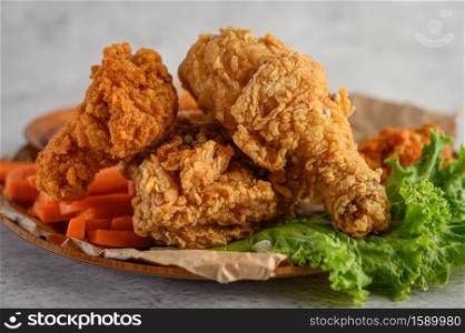 Crispy fried chicken on a plate with salad and carrot, Selective focus.