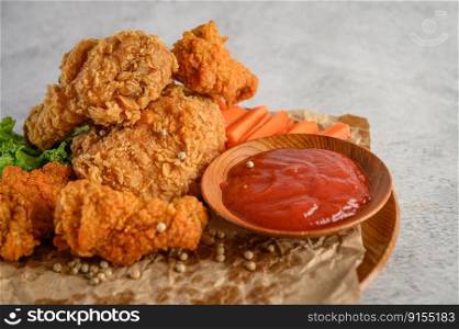 Crispy fried chicken on a plate with tomato sauce, Selective focus.