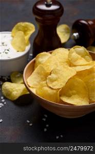 Crispy fried potato chips with salt and cream dip