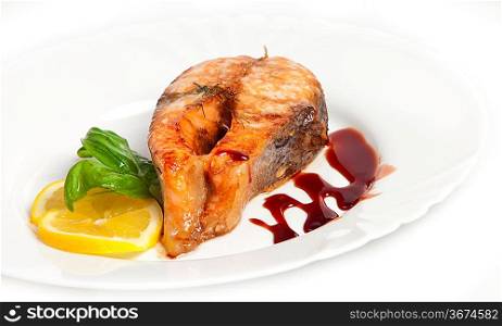 Crispy grilled salmon steak with lemon and basil