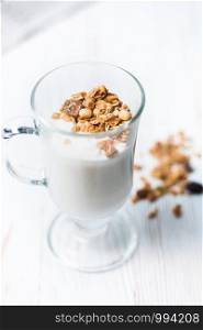 Crispy muesli in a glass with fresh yogurt, morning Breakfast, light snacks. Breakfast cereals isolated on white background, selective focus, top view.. Crispy muesli in a glass with fresh yogurt, morning Breakfast, light snacks. Breakfast cereals isolated on white background, selective focus, top view