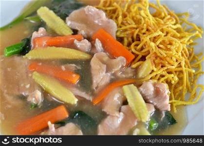 crispy yellow noodle with in a creamy gravy sauce