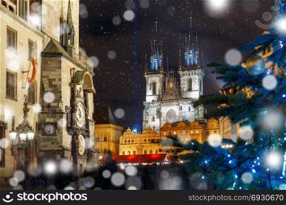 Cristmas Old Town square in Prague, Czech Republic. Old Town Hall with astronomical clock, Town Square with Christmas tree and fairy tale Church of our Lady Tyn in the magical city of Prague at snowy night, Czech Republic