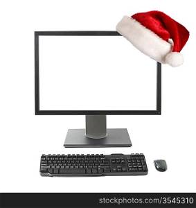Cristmas online shopping concept - Computer workstation (monitor, keyboard, mouse) monitor with Santa hat isolated on white background